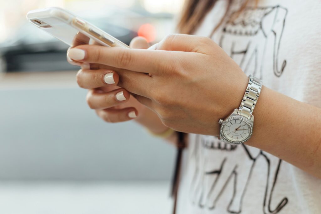 woman-holding-iphone-during-daytime